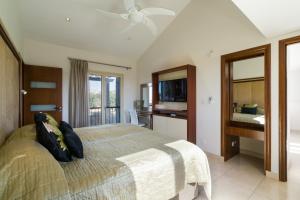 a bedroom with a bed with a ceiling fan at 5 bedroom Villa Rio with large private pool and hot tub, Aphrodite Hills Resort in Kouklia +51 photos