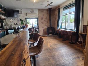 a long wooden table in a room with chairs at The Caramut Hotel in Caramut