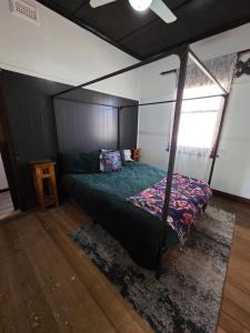a bedroom with a bed with a canopy at The Caramut Hotel in Caramut
