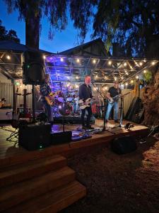 a band playing on a stage at night at The Caramut Hotel in Caramut