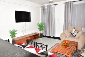 a living room with a couch and a table at Primestay Suites in Eldoret