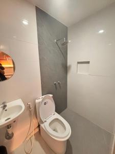 a bathroom with a toilet and a sink at Astrotel Cubao in Manila +58 photos