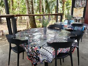 a table with a colorful table cloth on it at Gaharu glamping park in Jerantut