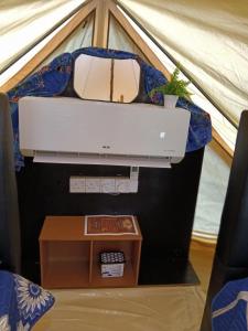 a computer in a tent with a table at Gaharu glamping park in Jerantut +38 photos