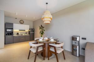 a kitchen and dining room with a table and chairs at Grey Stones - Private Pool Villa with Rooftop in Ungasan +24 photos