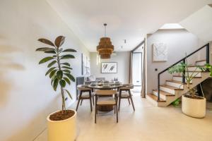 a dining room with a table and a potted plant at Grey Stones - Private Pool Villa with Rooftop in Ungasan