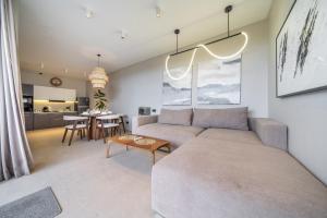 a living room with a couch and a table at Grey Stones - Private Pool Villa with Rooftop in Ungasan