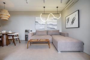 a living room with a couch and a table at Grey Stones - Private Pool Villa with Rooftop in Ungasan