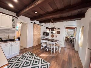 a kitchen and dining room with a table and chairs at Dandelion Vintage in Nemesgulács