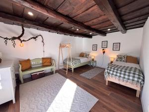 a bedroom with two beds and a couch at Dandelion Vintage in Nemesgulács