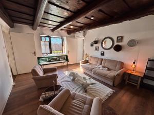 a living room with couches and a table at Dandelion Vintage in Nemesgulács