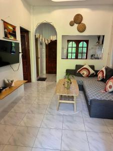 a living room with a couch and a table at My Home Resort - Koh phangan vacation house rentals in Ban Madua Wan