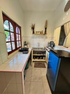 a large kitchen with a sink and a stove at My Home Resort - Koh phangan vacation house rentals in Ban Madua Wan