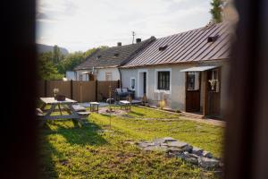a house with a picnic table in the yard at Dandelion Vintage in Nemesgulács