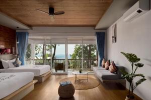 a living room with two beds and a couch at Pidoma Resort by EHM in Senmonorom +76 photos