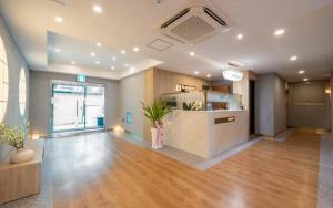a large room with a kitchen and a living room at H Avenue Hotel Gyeryong Eomsa branch in Gyeryong