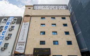 a building with a sign on the side of it at H Avenue Hotel Gyeryong Eomsa branch in Gyeryong