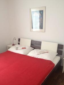 two beds in a room with a red blanket at Ferien Haus bei Wien in Hagenbrunn