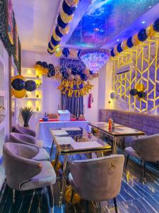 a room with tables and chairs in a restaurant at Fairtex Luxury Hotels in Maiyegun