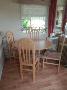a dining room table and two chairs and a table and a table at Le petit Paradis d'Hetty in Buxières-sous-Montaigut +8 photos