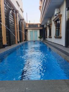 a swimming pool with a water hose in a building at Da Rucci Hotel syariah in Medan