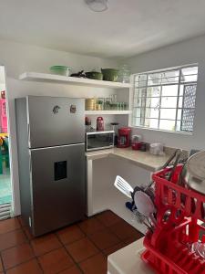 a kitchen with a stainless steel refrigerator and a counter at Cozy house near downtown in Orizaba