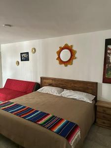 a bedroom with a bed and a mirror on the wall at Cozy house near downtown in Orizaba