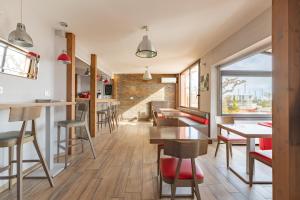 a kitchen and dining room with tables and chairs at Logis Mar I Sol - Hôtel Restaurant en bord de Mer in Saint-Cyprien