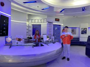 two people standing in a room with a boat at Astrotel Cubao in Manila