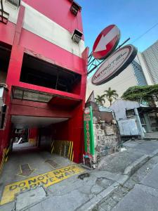 a red building with a do not enter sign on it at Astrotel Cubao in Manila