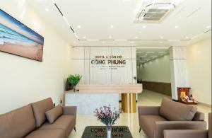 a lobby with two couches and a giving thing sign at Hotel & Apartment Cong Phung in Ấp Bình Hưng