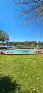 a park with two picnic tables and a lake at Critchley Hackle - Tower rooms in Dullstroom