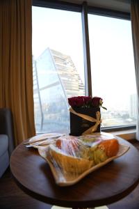 a table with a plate of food and a bouquet of roses at The Murti Hotel and Banquet in Noida