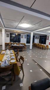 a dining room with tables and chairs in a room at Njiro Luxury in Arusha