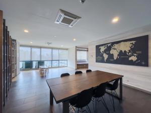 a conference room with a wooden table and a map on the wall at Luxury Condo Datum Jelatek Near KLCC,free Parking in Kampong Datok Keramat +64 photos
