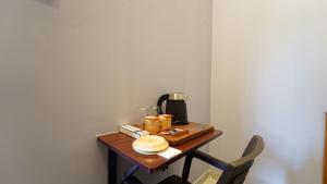 a table with a coffee maker on top of it at MM Hotel Grey Luxury in Coimbatore