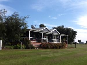 a house in a field next to a field at Redtail Cottages in Hester