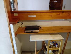 a laptop sitting on top of a wooden desk at HOTEL Saboten Apartment in Miyoshi