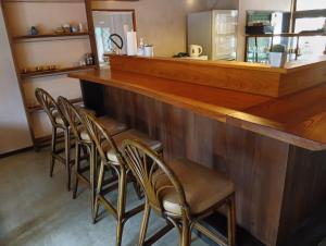 a row of chairs at a bar in a restaurant at HOTEL Saboten Apartment in Miyoshi