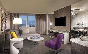 a living room with a couch and a piano at Hyatt Regency Los Angeles International Airport in Los Angeles