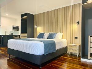 a bedroom with a large bed and a kitchen at Ocean Outlook Retreat in River Heads +14 photos