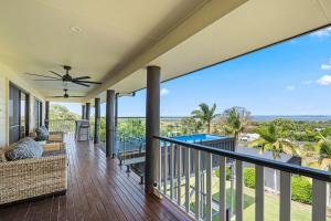 a house with a balcony with a view of the ocean at Ocean Outlook Retreat in River Heads