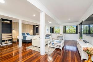 a large living room with a bed and a couch at Ocean Outlook Retreat in River Heads