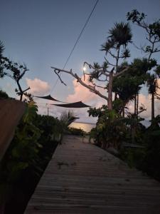 a wooden path leading to the beach at sunset at L' ecrin de douceur in Saint-Benoît