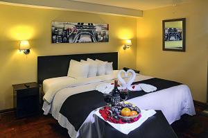 Ein Bett oder Betten in einem Zimmer der Unterkunft Casona Plaza Hotel Centro