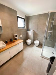 a bathroom with a shower and a toilet and a sink at Villa Martina in Novigrad Istria