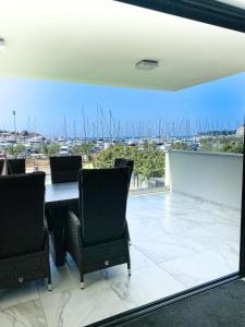 a dining room with a table and chairs and a view of a harbor at Villa Martina in Novigrad Istria