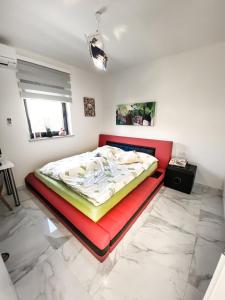 a bed in a room with a red bed frame at Villa Martina in Novigrad Istria +45 photos