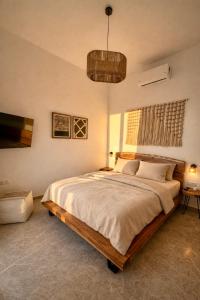 a bedroom with a large bed in a room at Kyma Sunset Suite w Prvate Jacuzzi in Paros National Airport