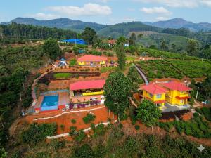an aerial view of a house on a hill at Velvet Oasis Cottages in Vythiri